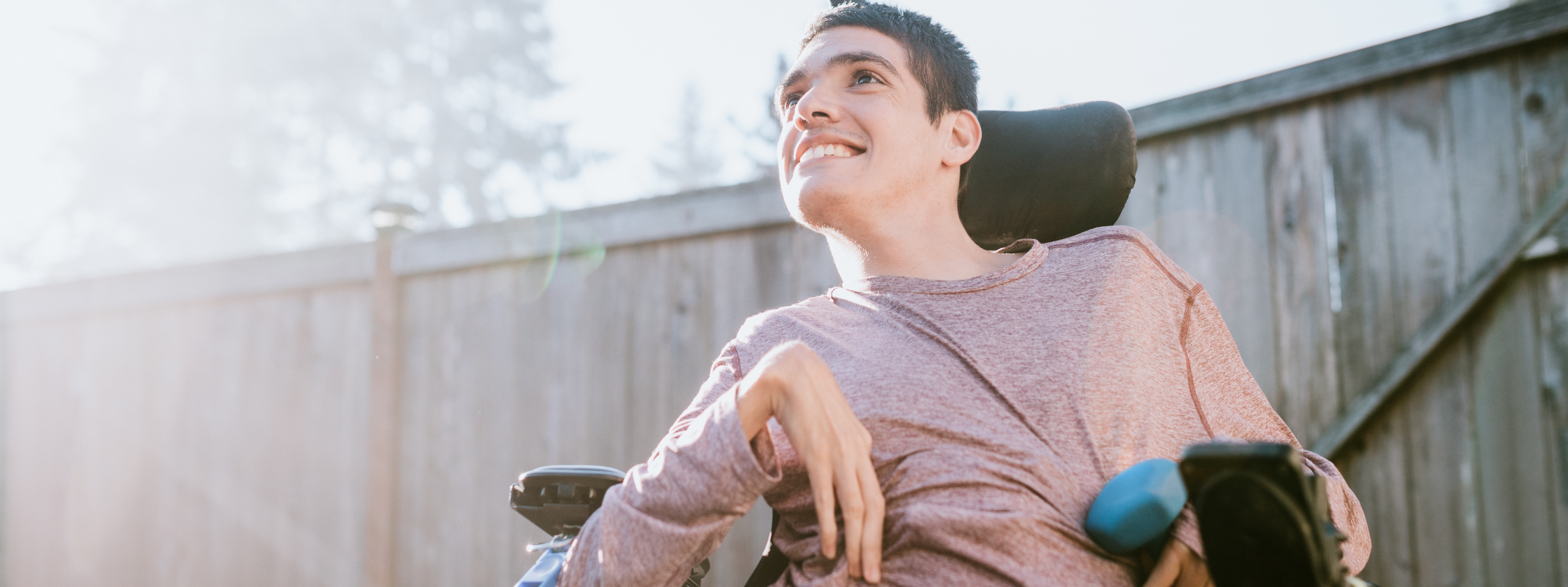 Young man in a wheelchair smiling